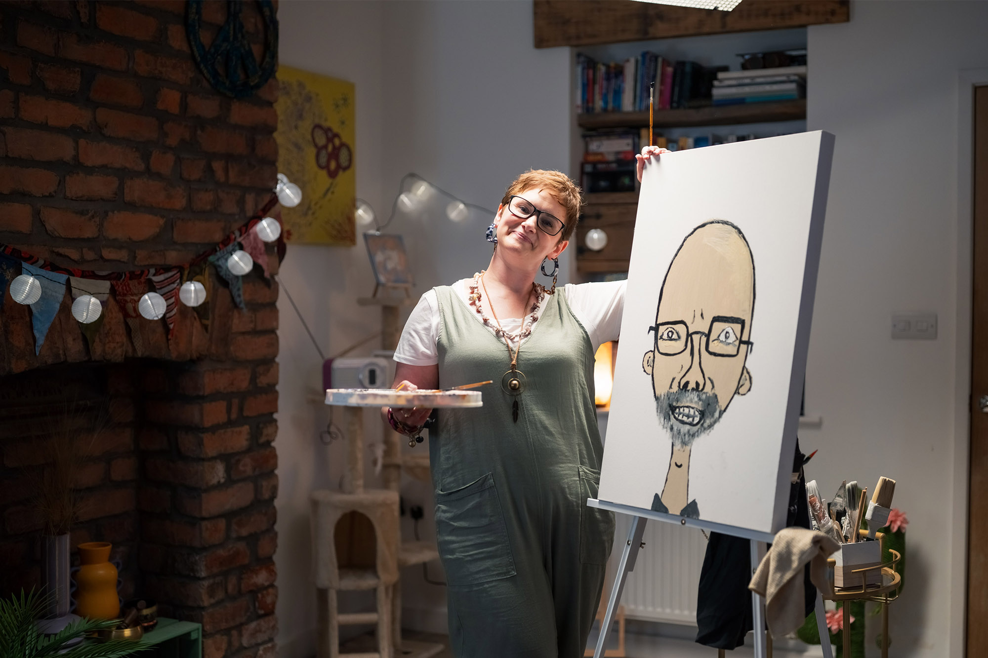 Artist stood next to portrait