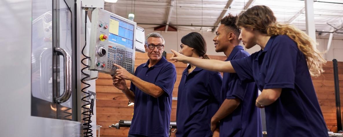 Apprentices with an engineering tutor