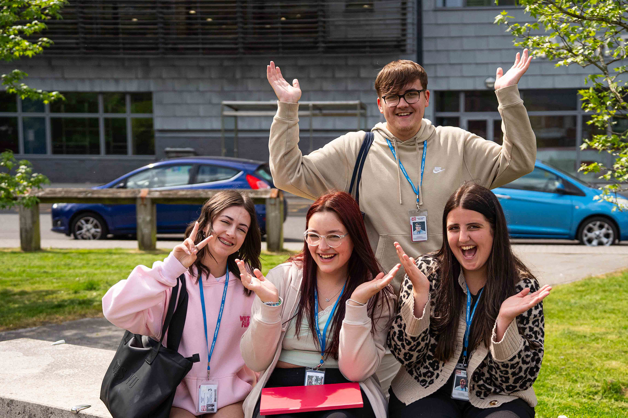 Students sat outside BGLZ with hands in the air