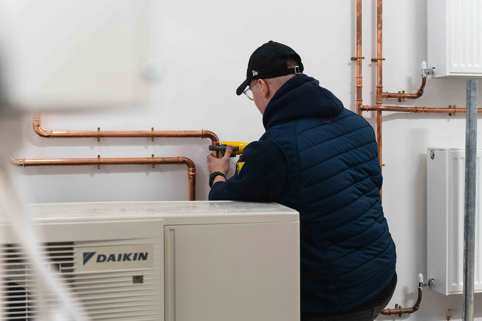 Student connecting heat pump