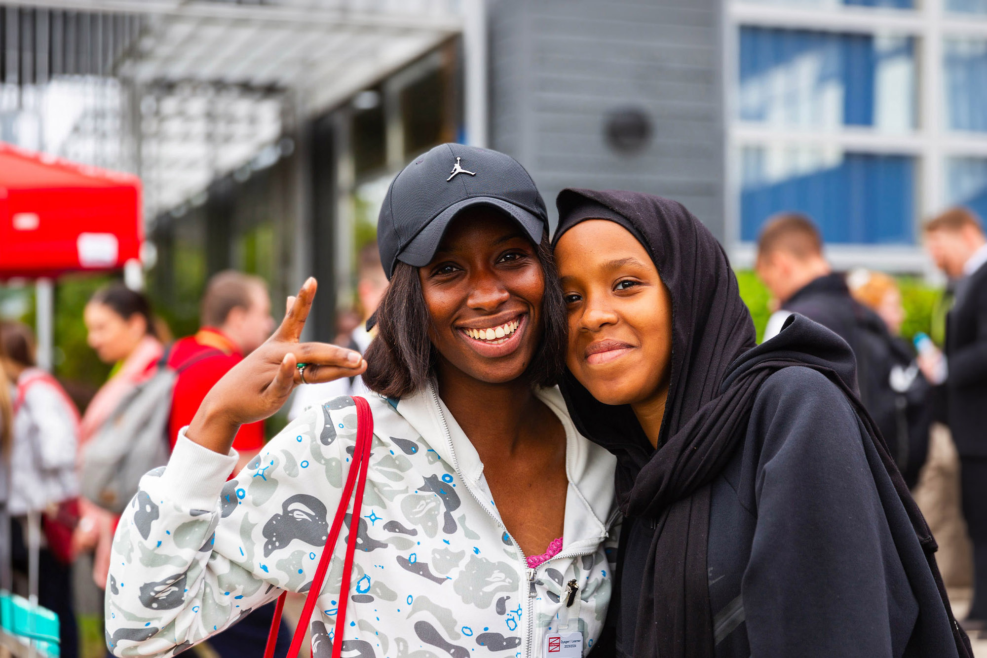 Two visitors smiling at an event